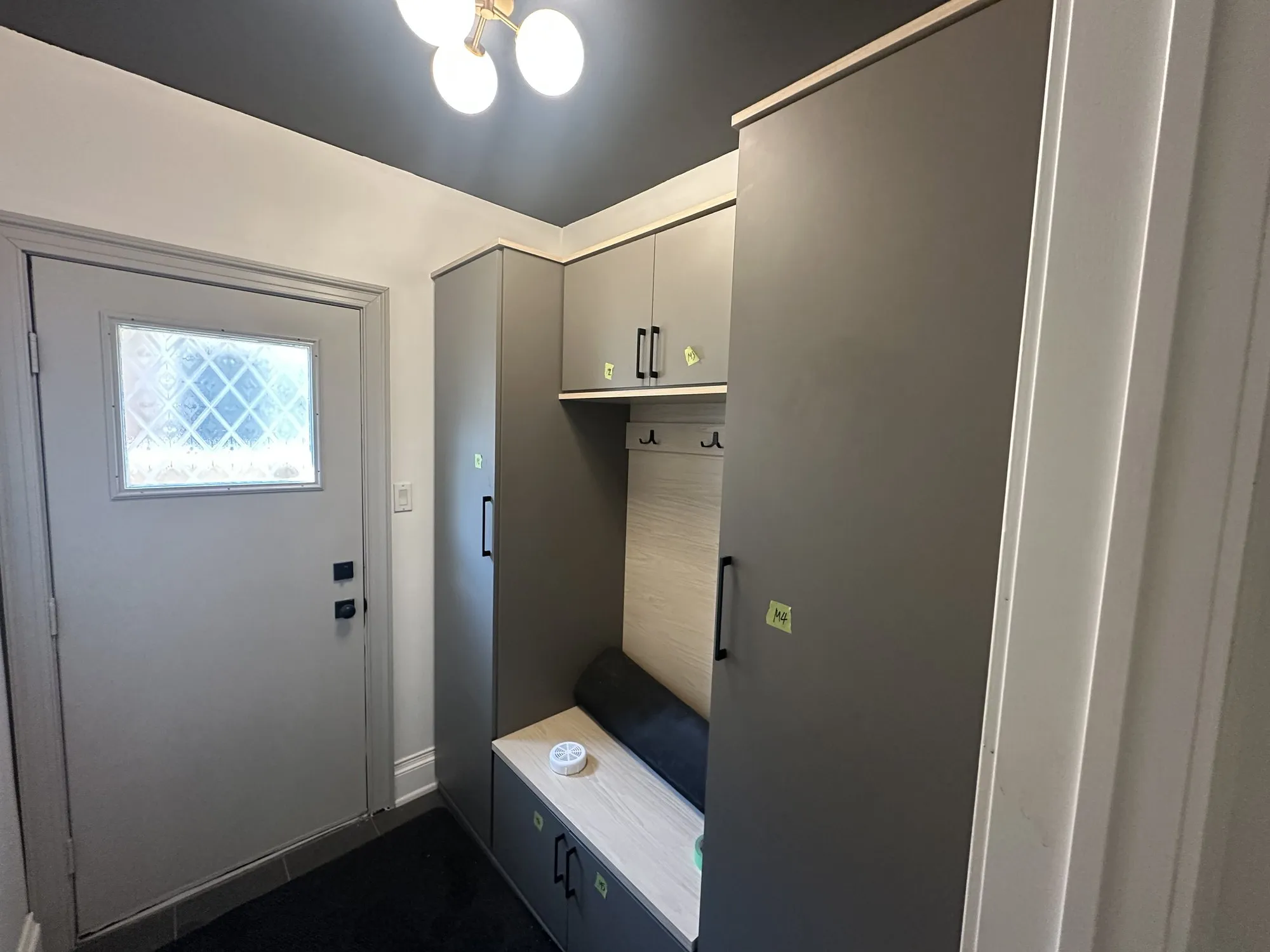 The mudroom off the kitchen, its bench and tall lockers sprayed in the same colours as the kitchen cabinets