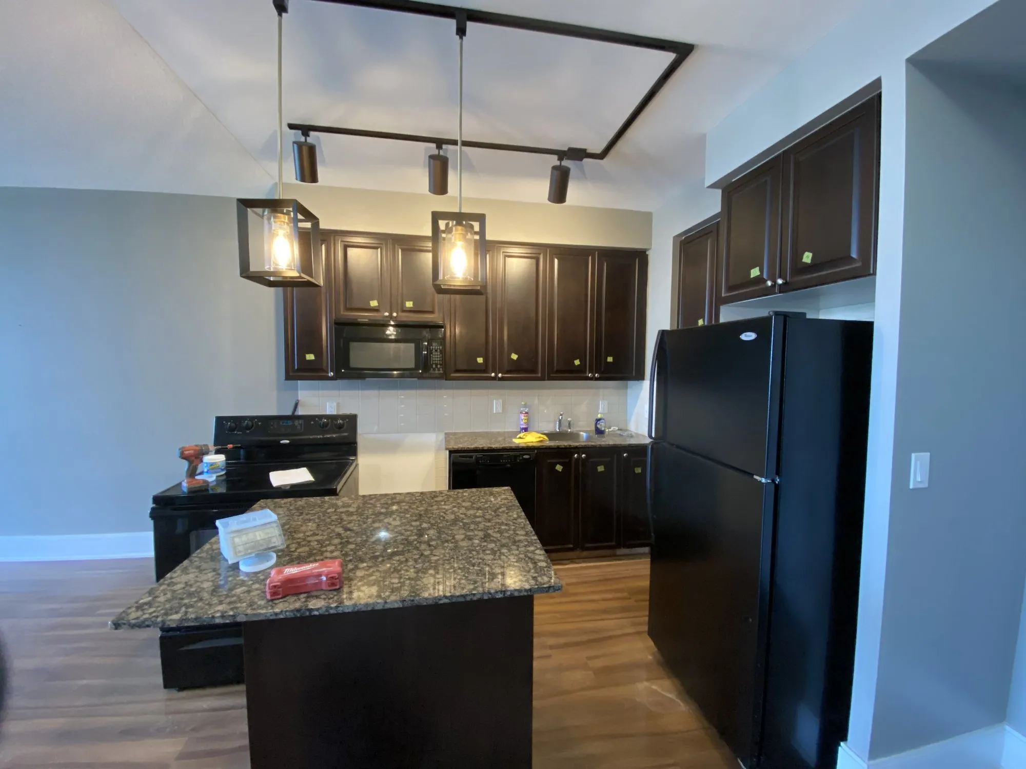 Before — espresso repainted cream, island extended and finished in a second colour in City Centre, Mississauga