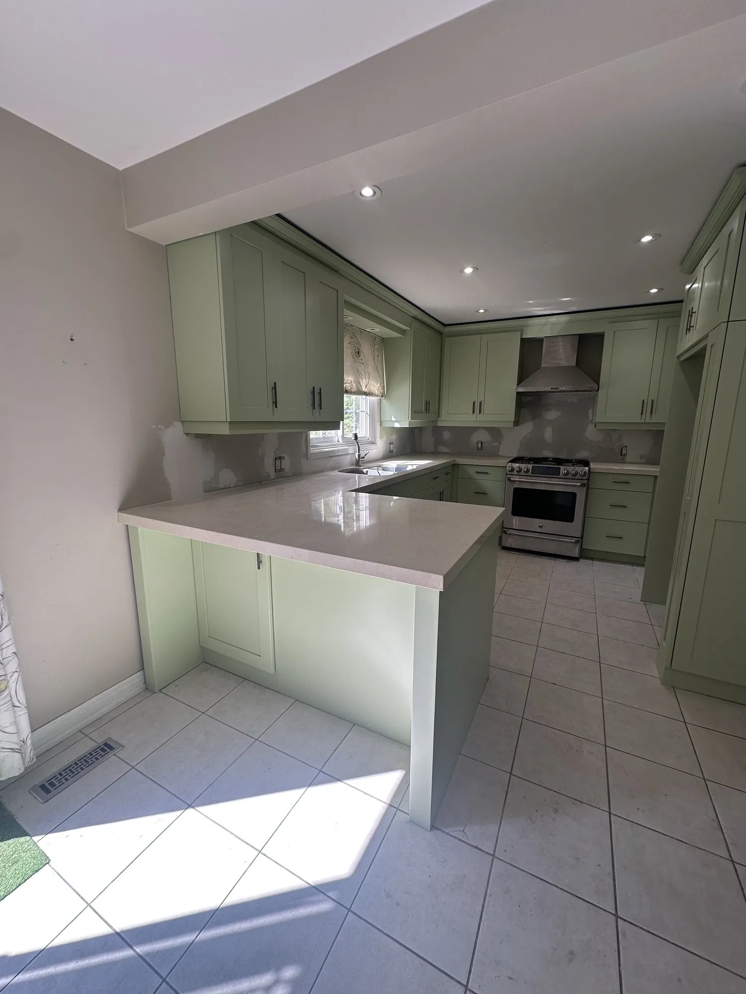 After — espresso sprayed a light green, new handles, cabinets only in Erin Mills, Mississauga
