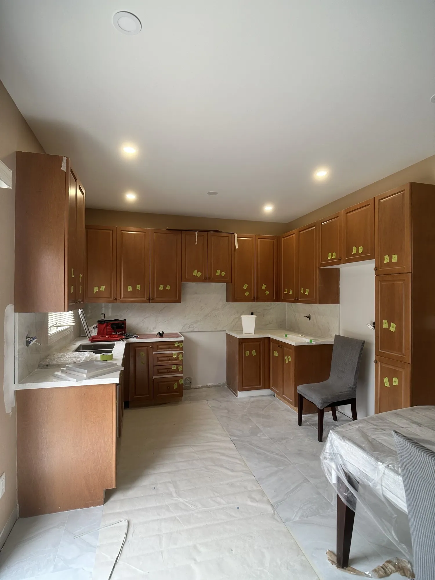 Before — oak sprayed Platinum Gray, crown moulding added, matte black handles in Vellore Village, Vaughan