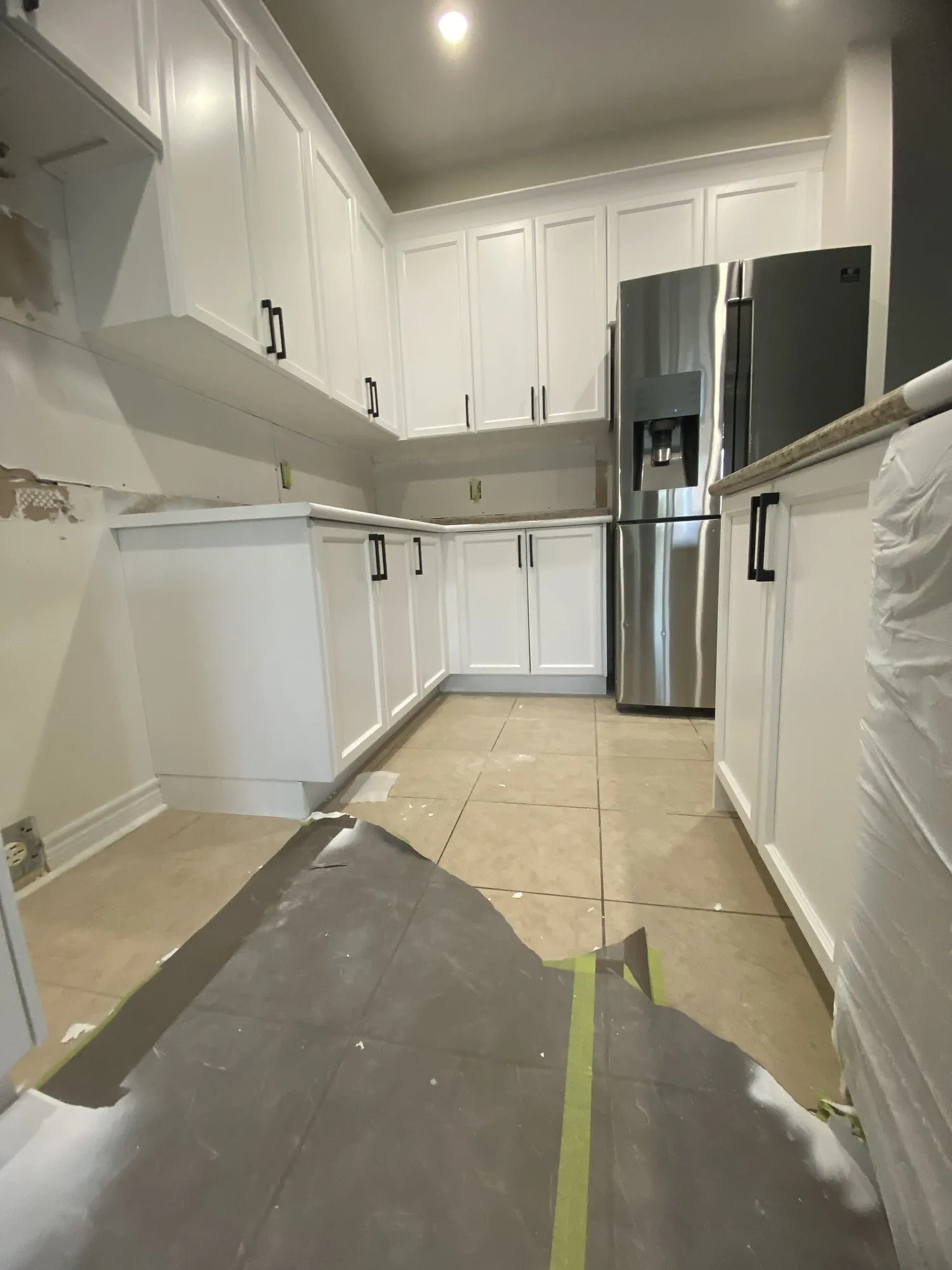 The run part way through installation, the new crown moulding already up and finished white, floors still fully sheeted