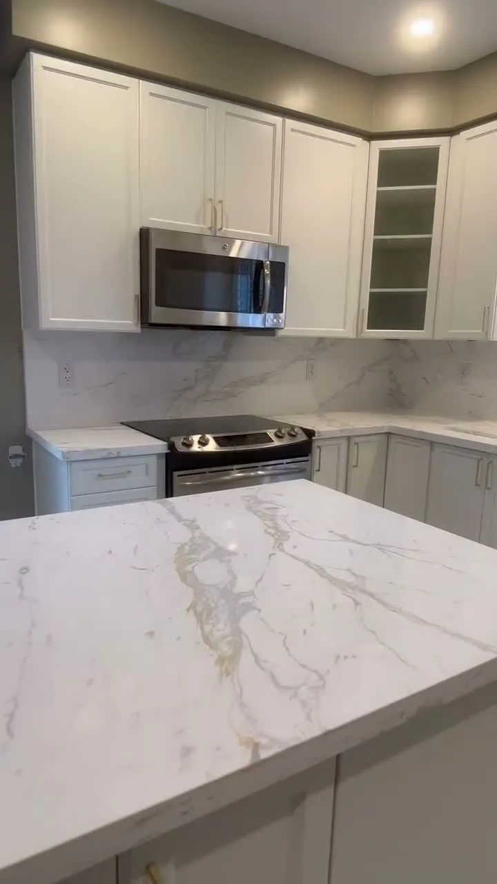A walk through the finished Northeast Ajax kitchen — white cabinetry where dark espresso was, and an island run long enough to seat a family under a single quartz top