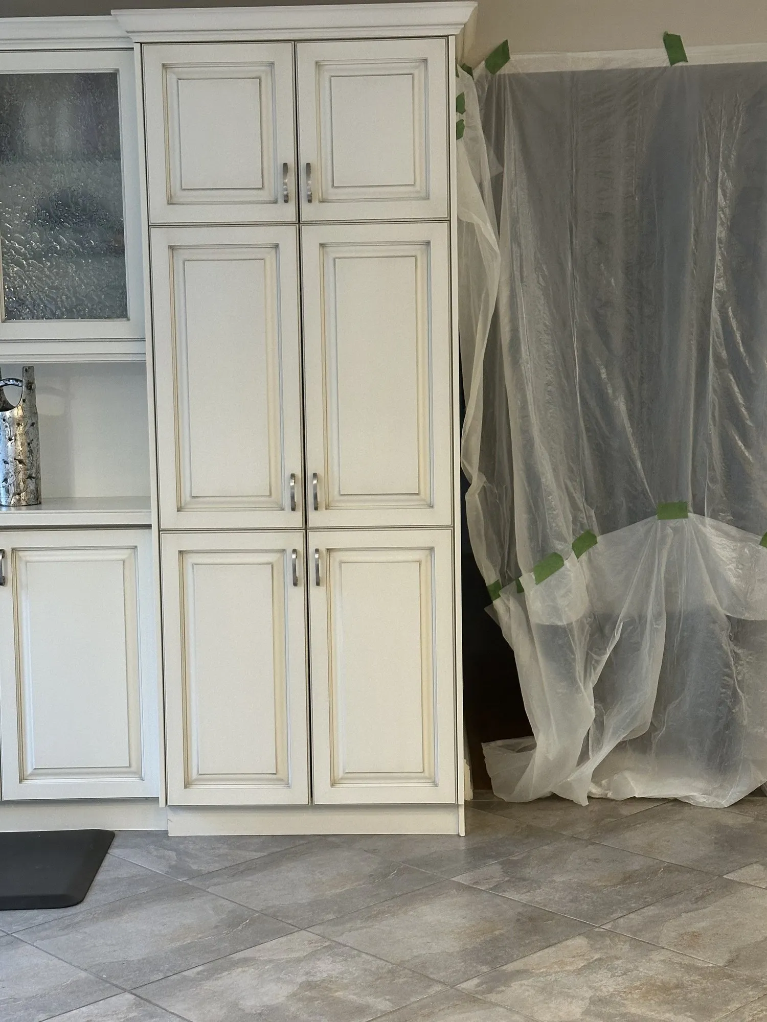 An original cream cabinet showing the glaze settled into the corners of the raised panel profile and along the edges of the frame
