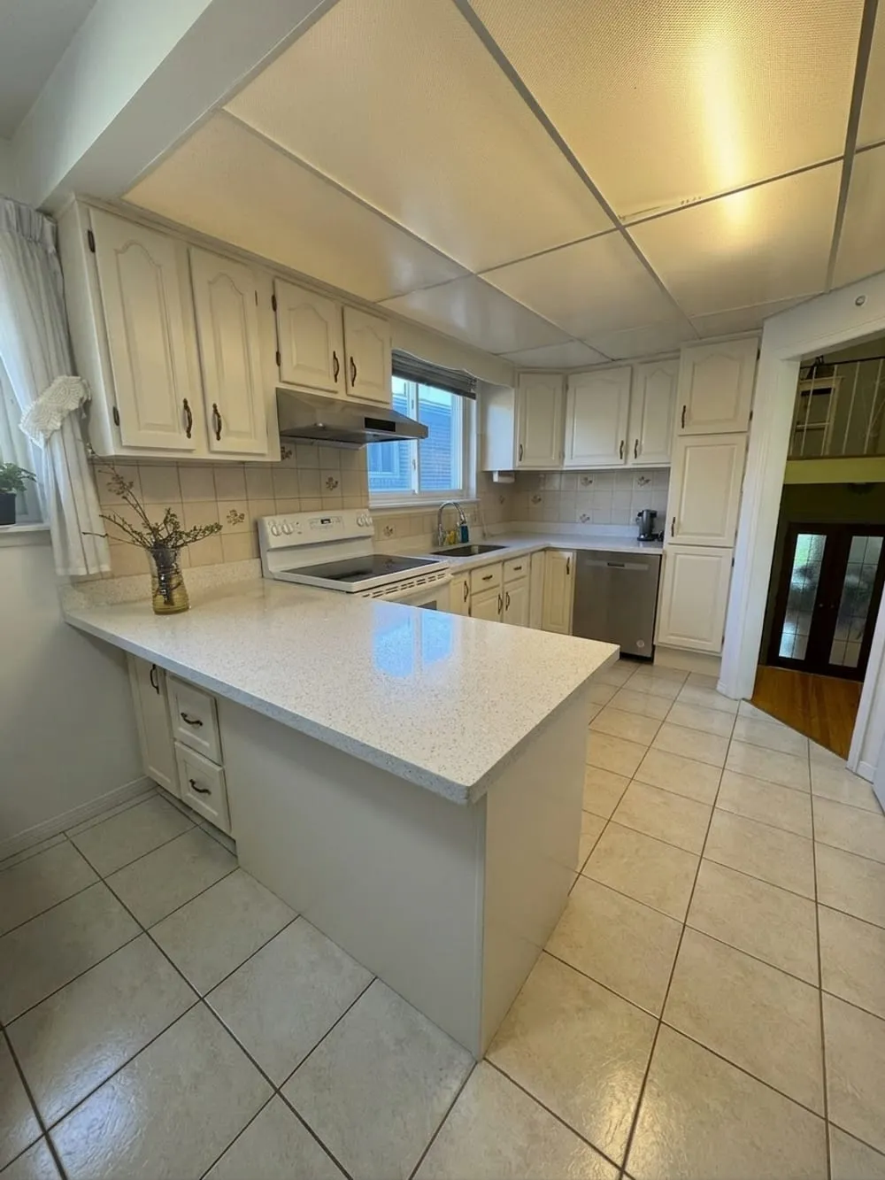 A preview generated by the colour visualiser showing a kitchen with its dark oak cabinets repainted white