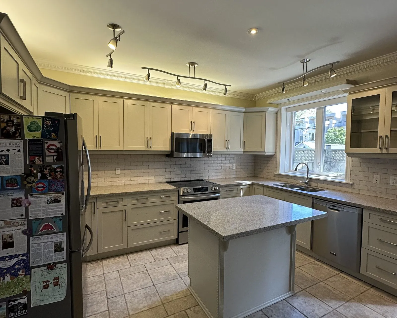 After — blonde maple sprayed greige, new quartz and a fresh backsplash — Glenorchy, Oakville
