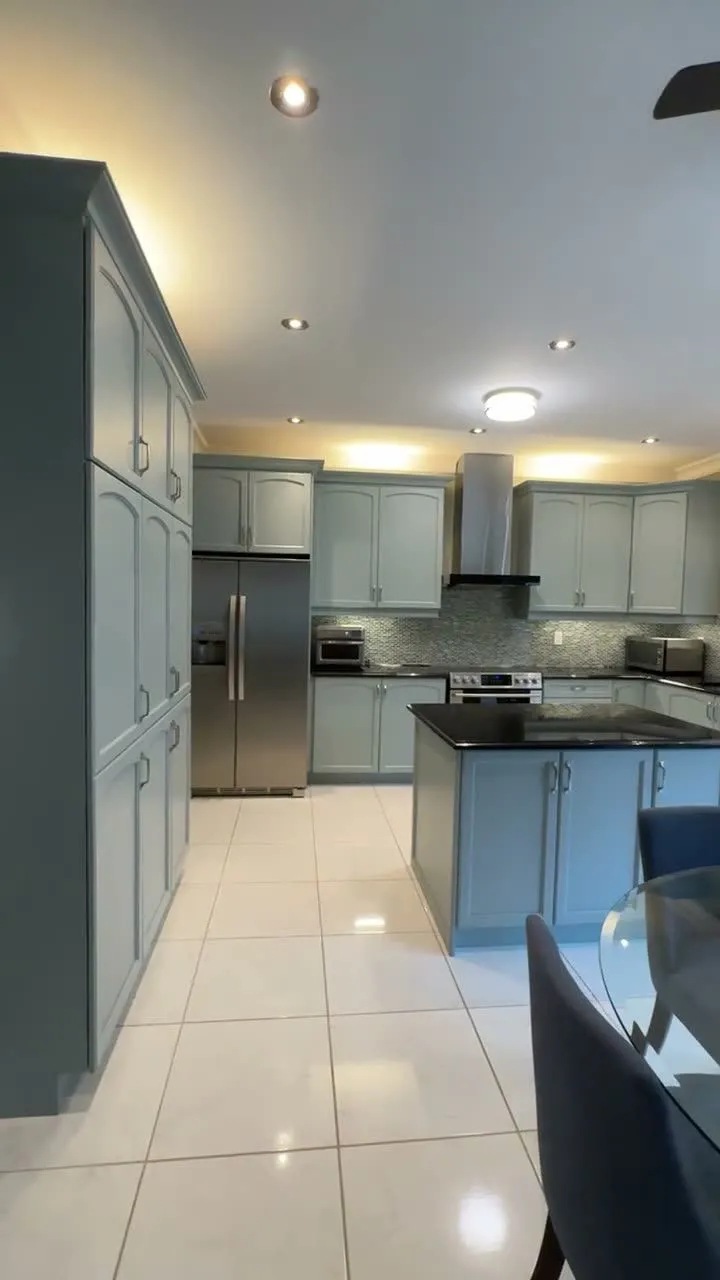 Walkthrough of the finished Jefferson kitchen — dark cherry cabinetry sprayed Boothbay Gray, the island extended, brushed nickel pulls, black countertops and a glass mosaic backsplash