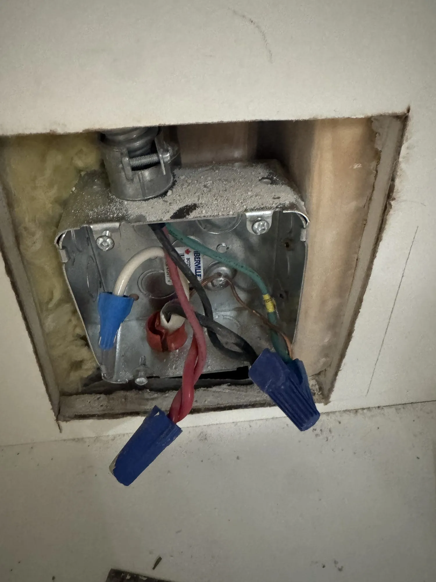An electrical box set into the opened wall during the beverage station installation, wiring visible