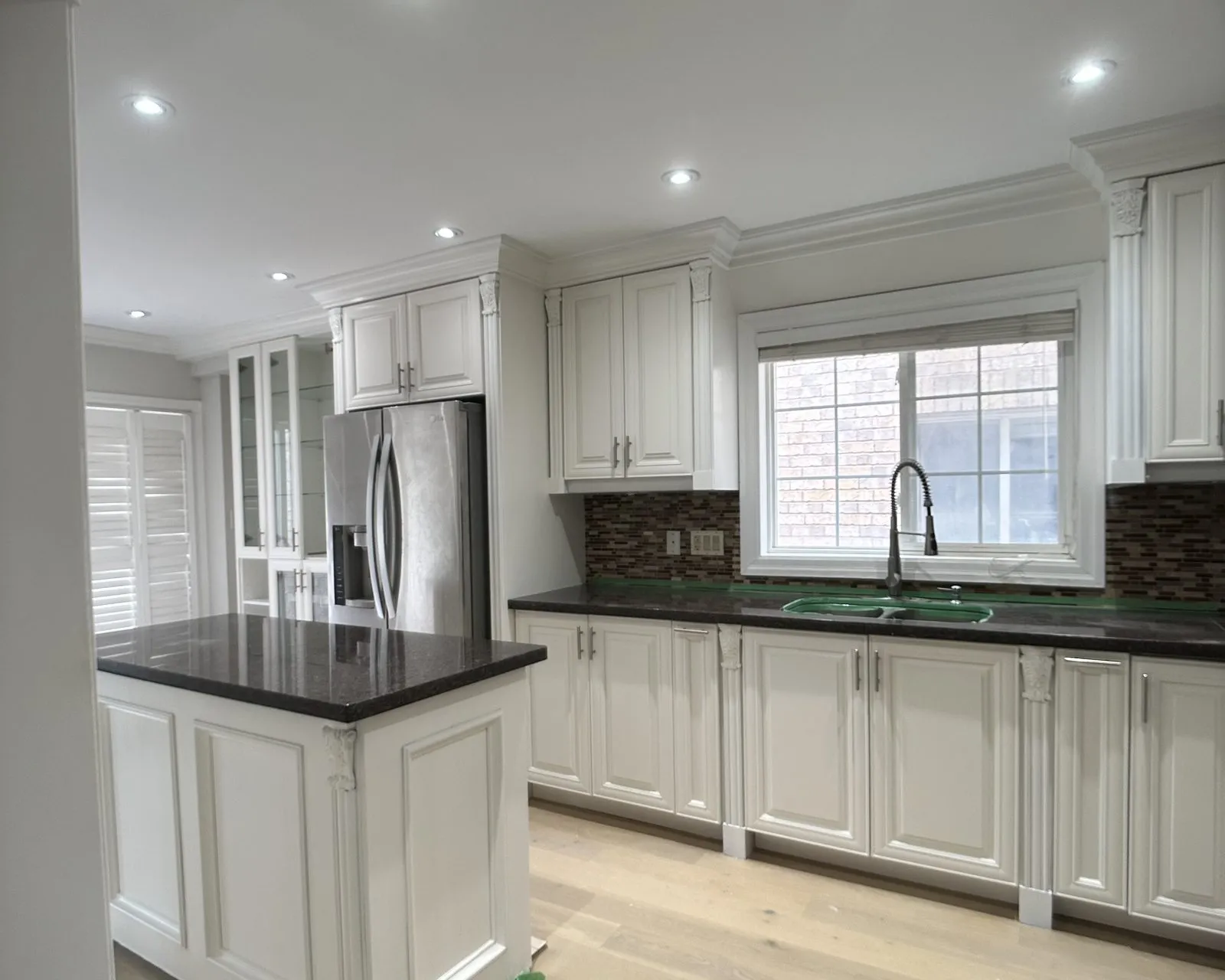 After — dark espresso sprayed White Dove, granite kept, floor and range by others — Vellore Village, Vaughan