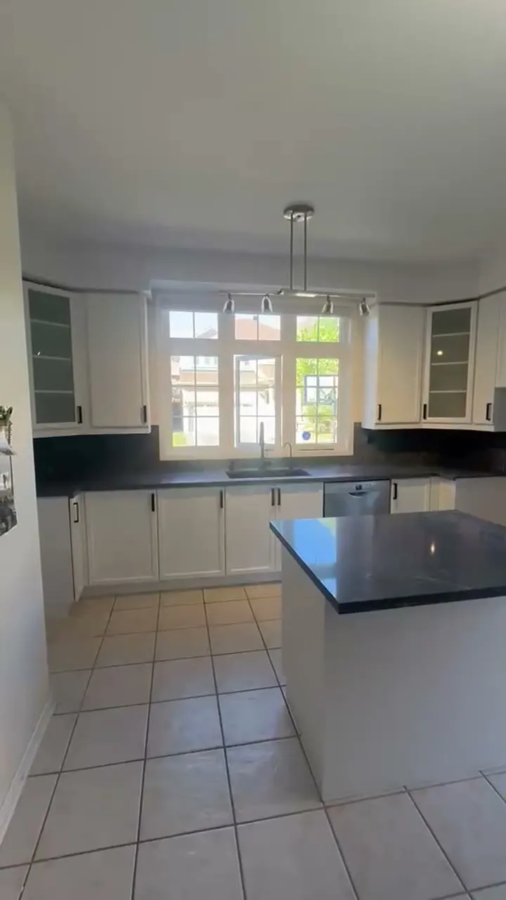 Walkthrough of the finished Wismer kitchen — dark cherry cabinetry sprayed Oxford White with matte black pulls, new dark countertops and backsplash
