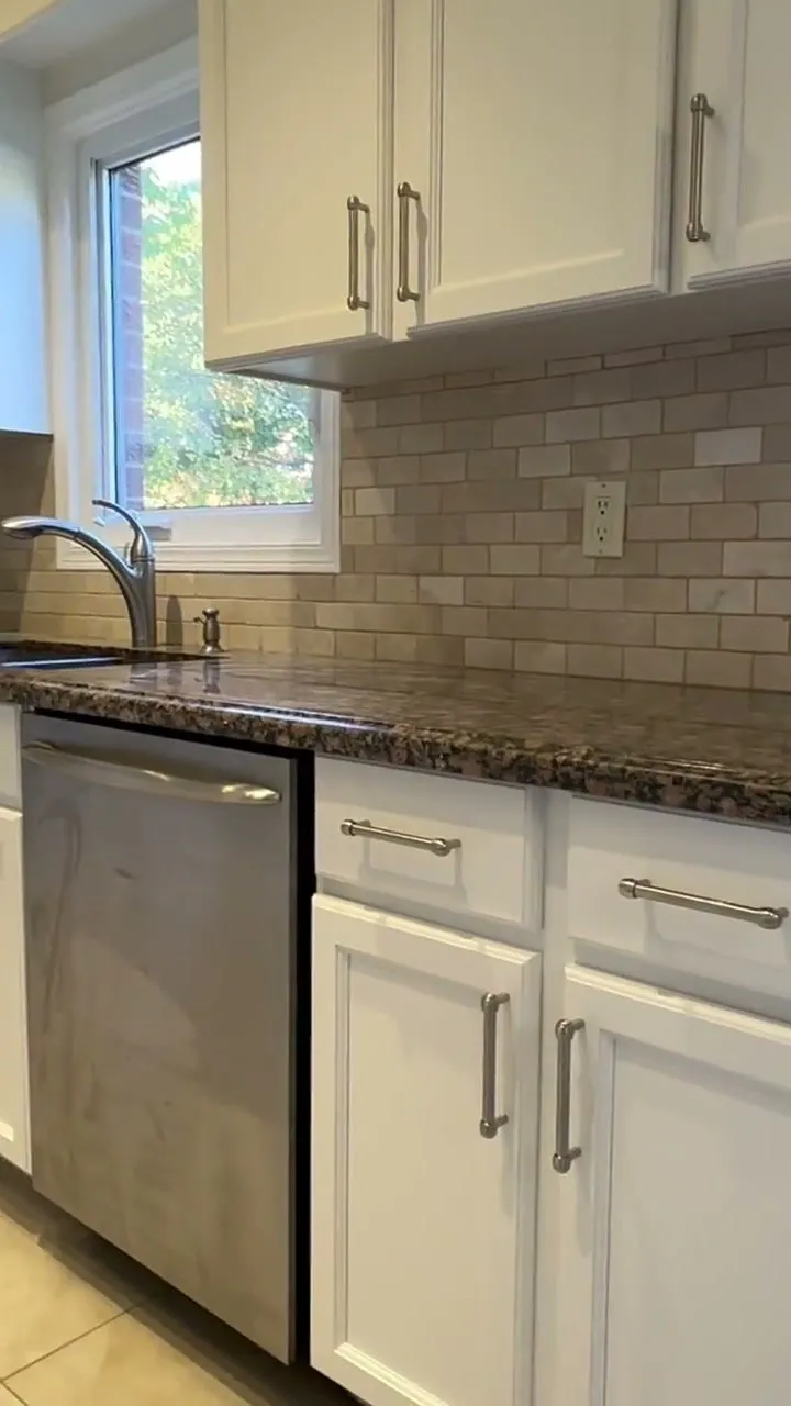 Walkthrough of the finished Mill Pond kitchen, with new white Shaker doors, brushed nickel bar pulls, granite countertops and a stone tile backsplash