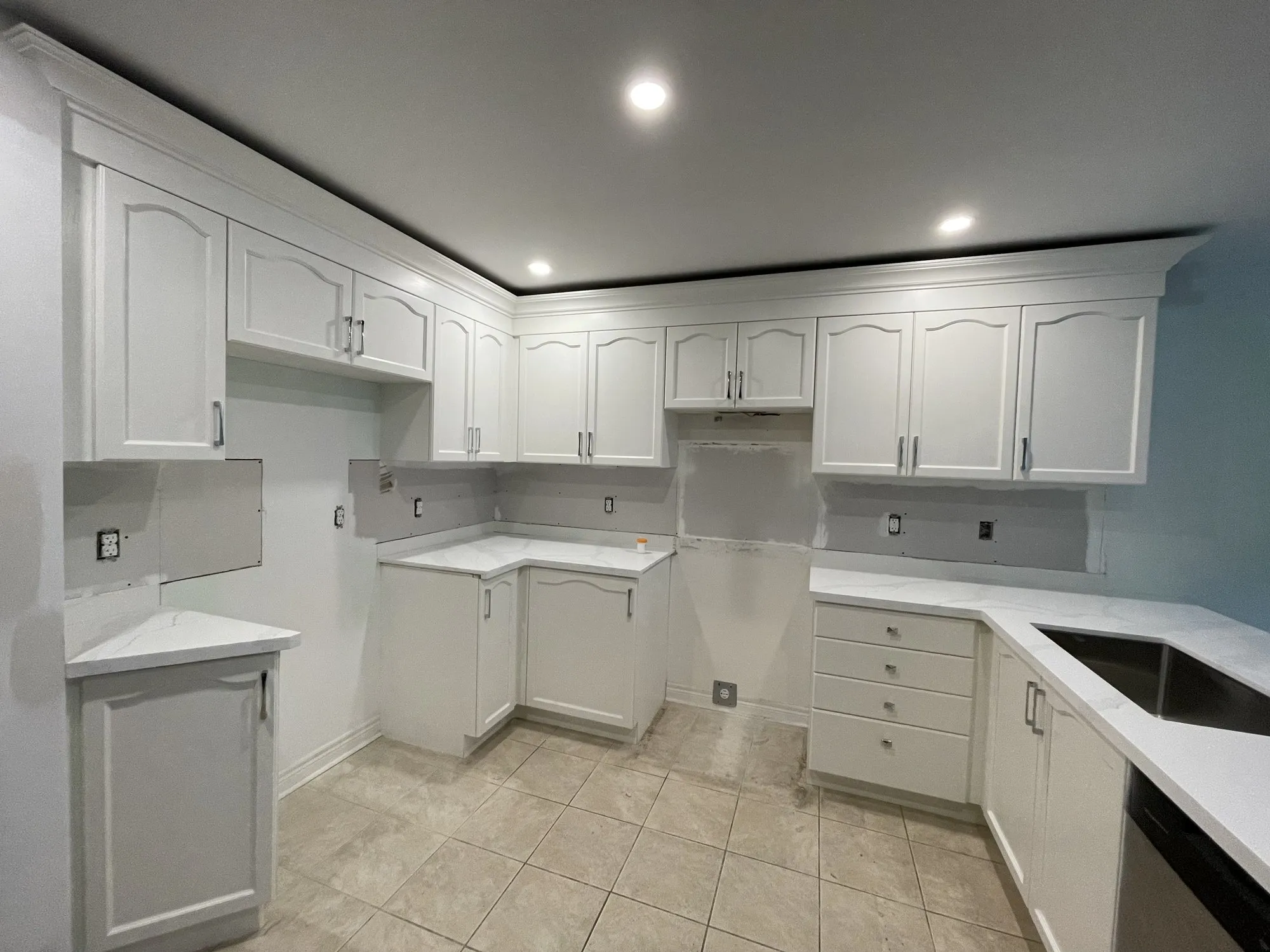 After — whitewashed oak refinished white, crown moulding added, new quartz and sinks in Rouge Woods, Richmond Hill