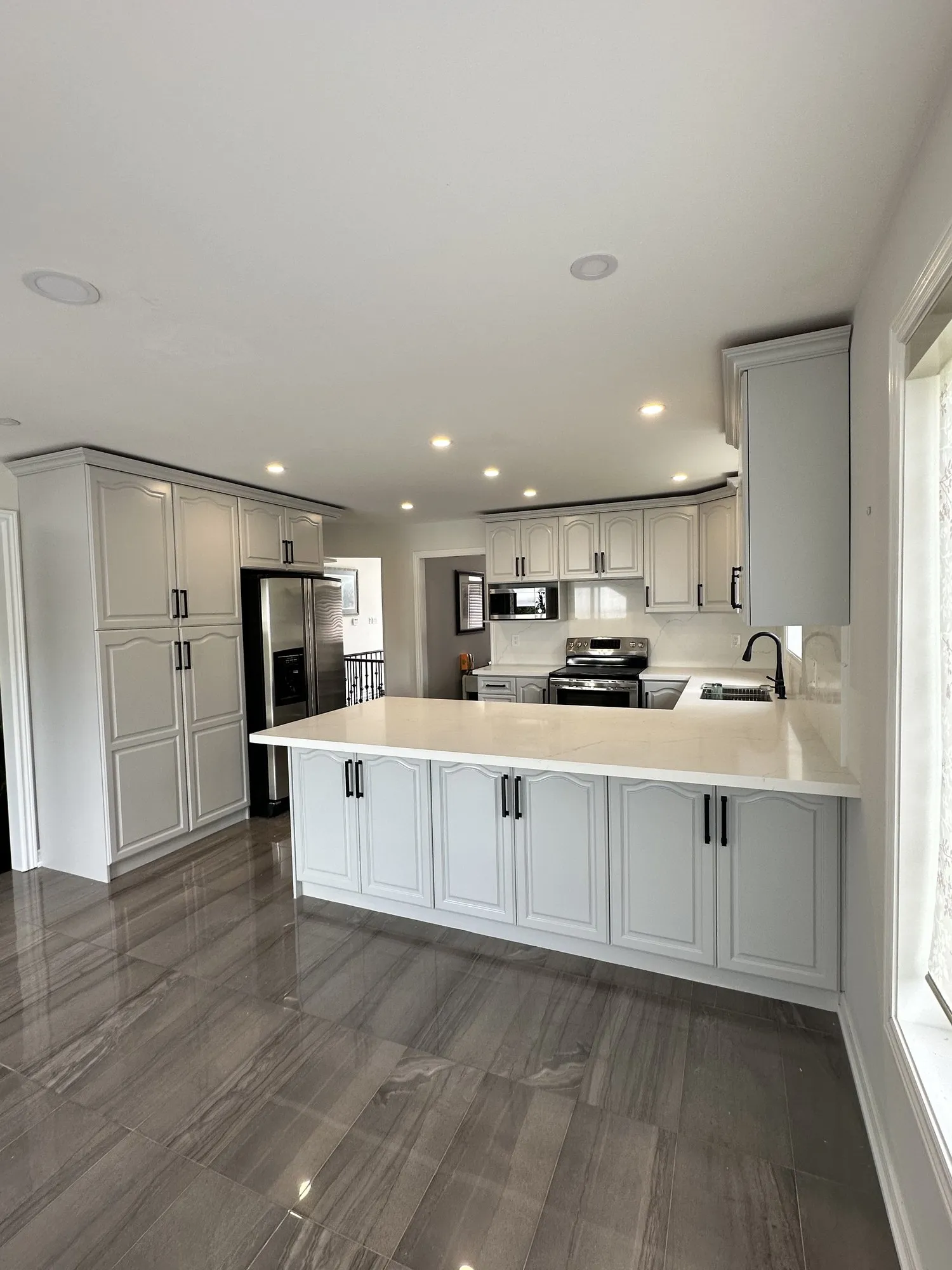 After — walnut refinished white, nine glass doors replaced with solid MDF in Rouge Woods, Richmond Hill