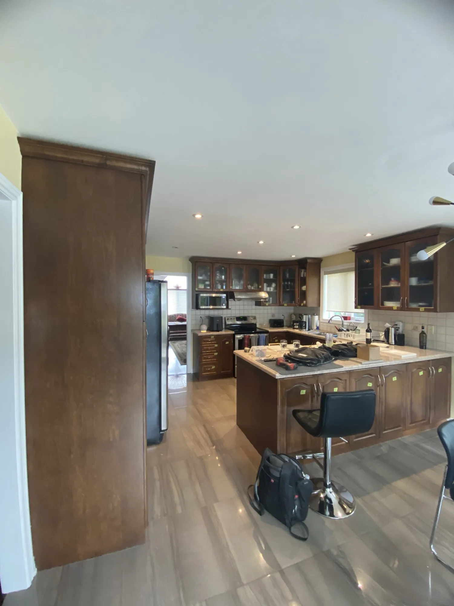 Before — walnut refinished white, nine glass doors replaced with solid MDF in Rouge Woods, Richmond Hill
