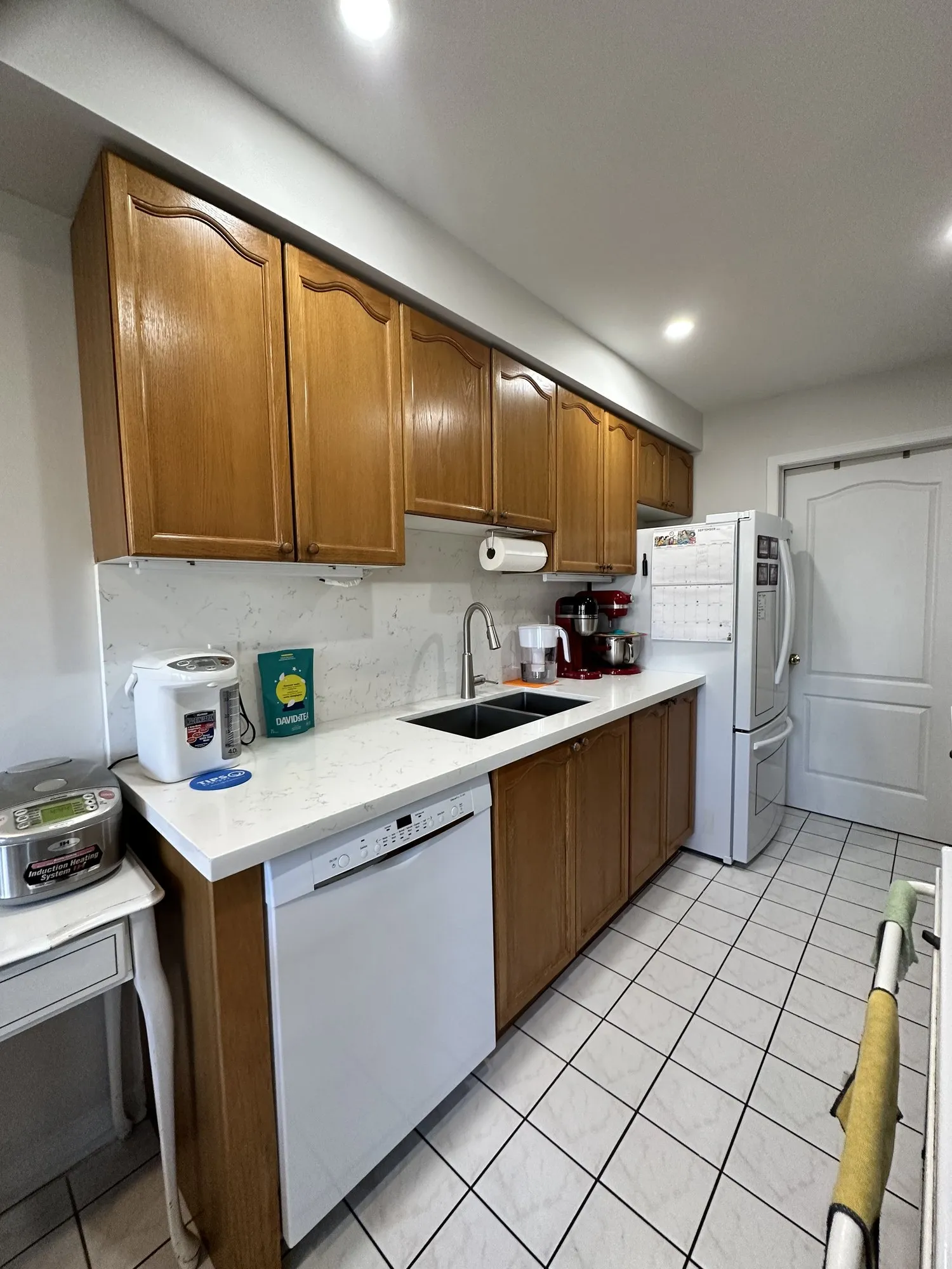 Before — oak refinished pure white, seven new soft-close drawers built to the contents in Bayview Wellington, Aurora