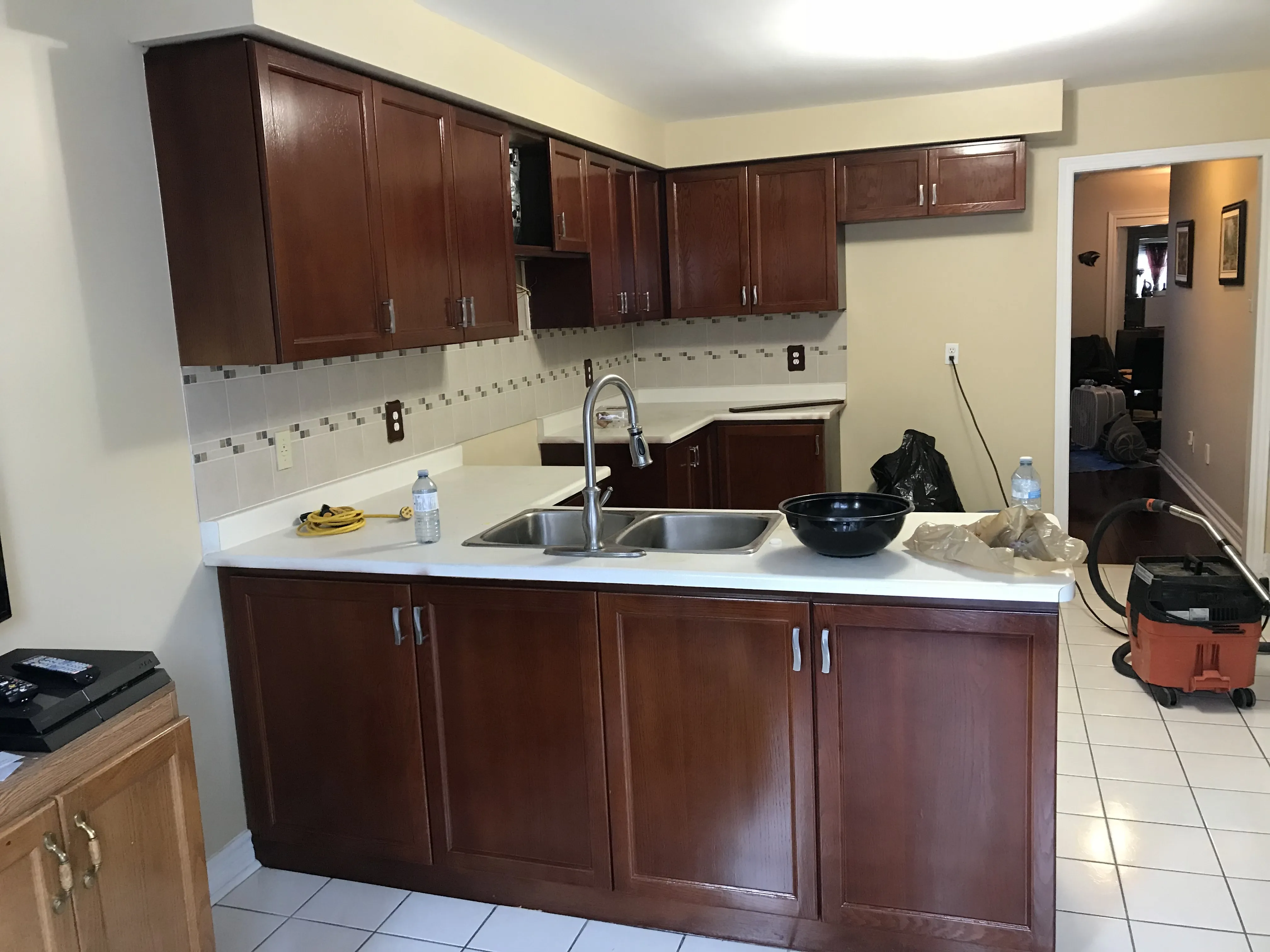 A kitchen finished in a rich dark stain, the wood grain reading clearly through the colour