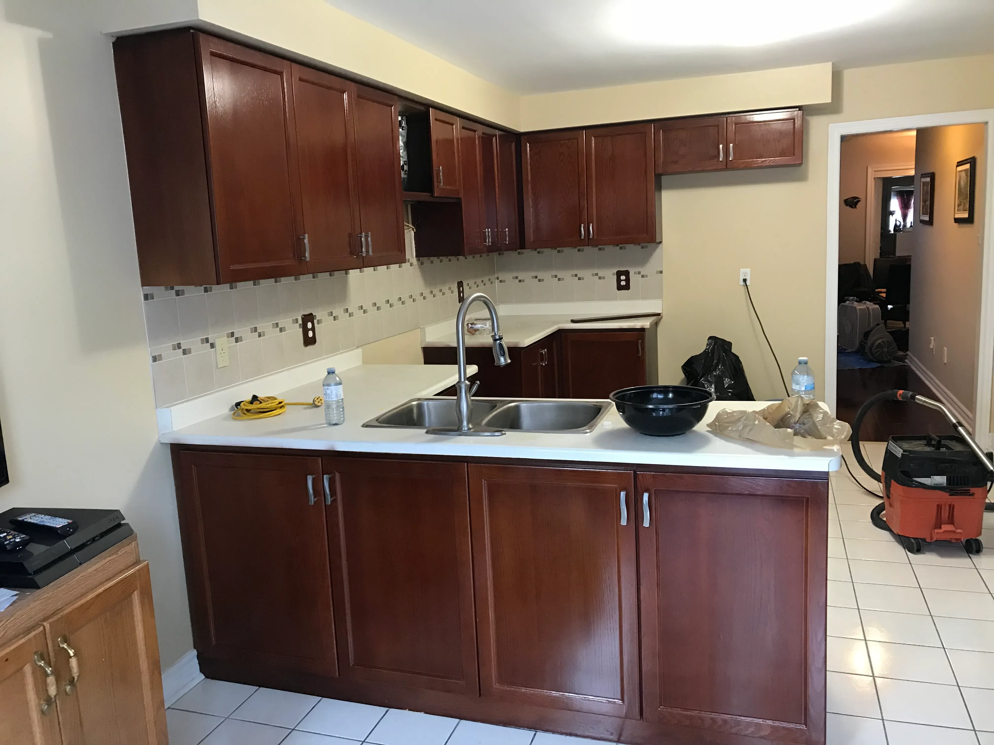 A kitchen finished in a rich dark stain, the wood grain reading clearly through the colour