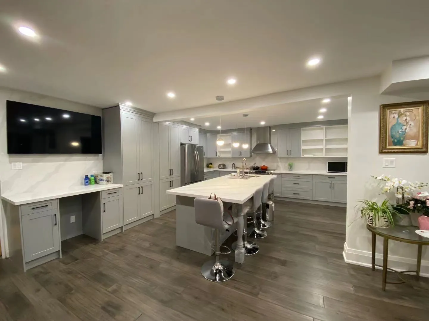 A finished grey kitchen with a large island, doors sprayed to a smooth even finish with no brush marks