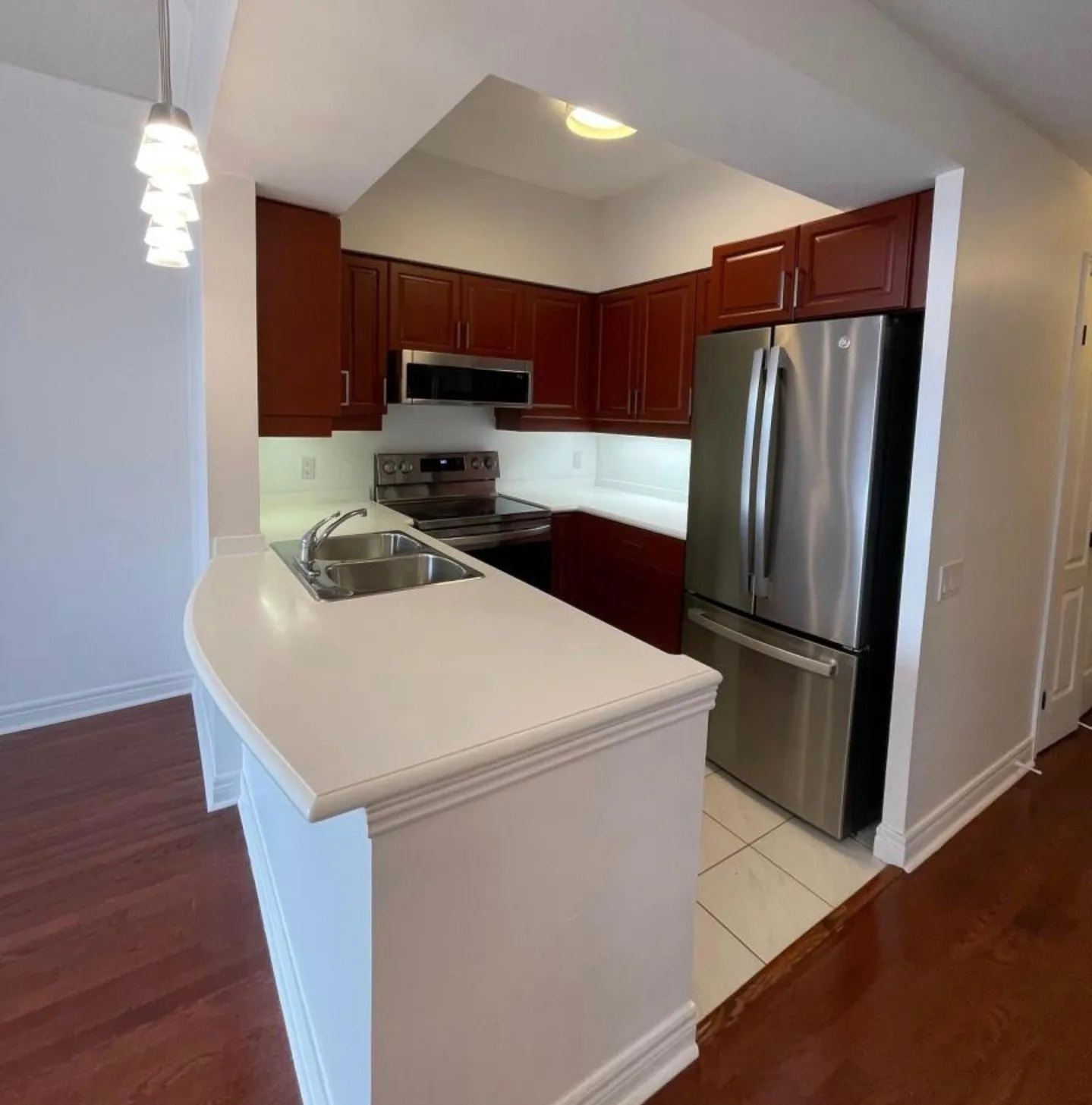 The finished kitchen in Country Redwood, the sink peninsula on the left and the fridge on the right
