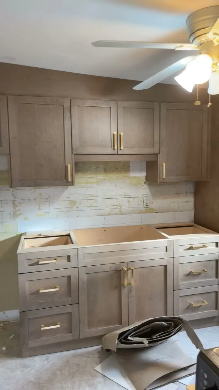 The Weston-Pellam Park kitchen on installation day, the new stained run standing in place with its doors and handles on and the countertop not yet down