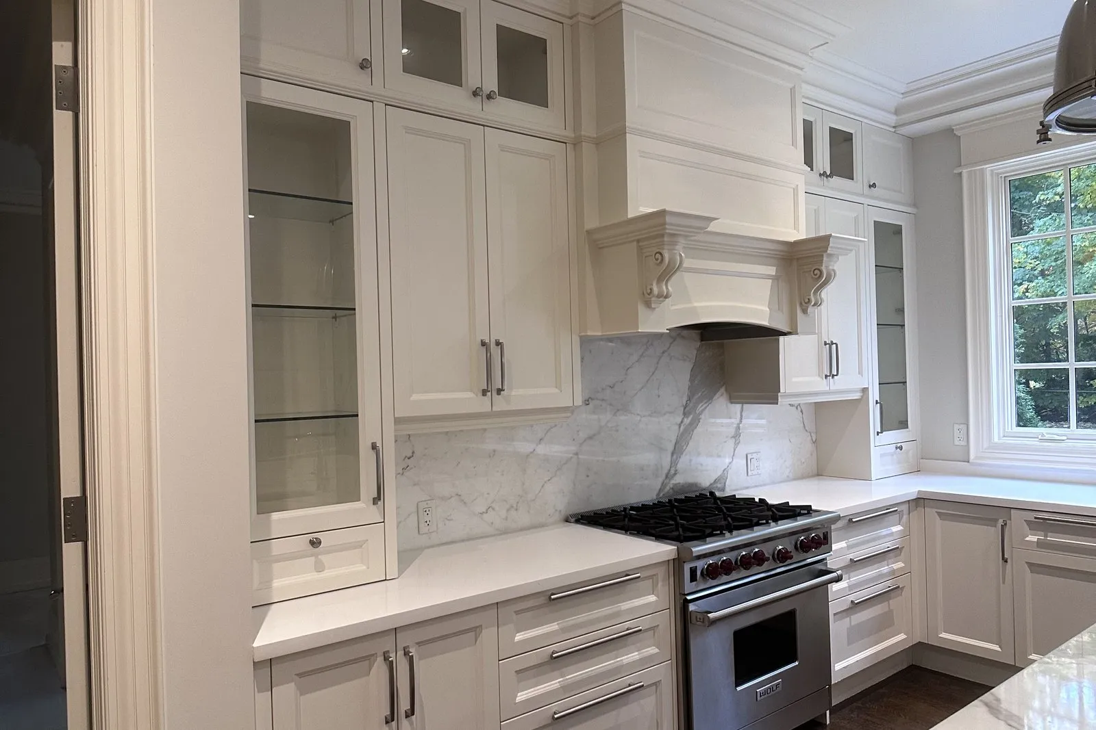 A finished kitchen run with the counters and splashback fitted against the installed cabinetry
