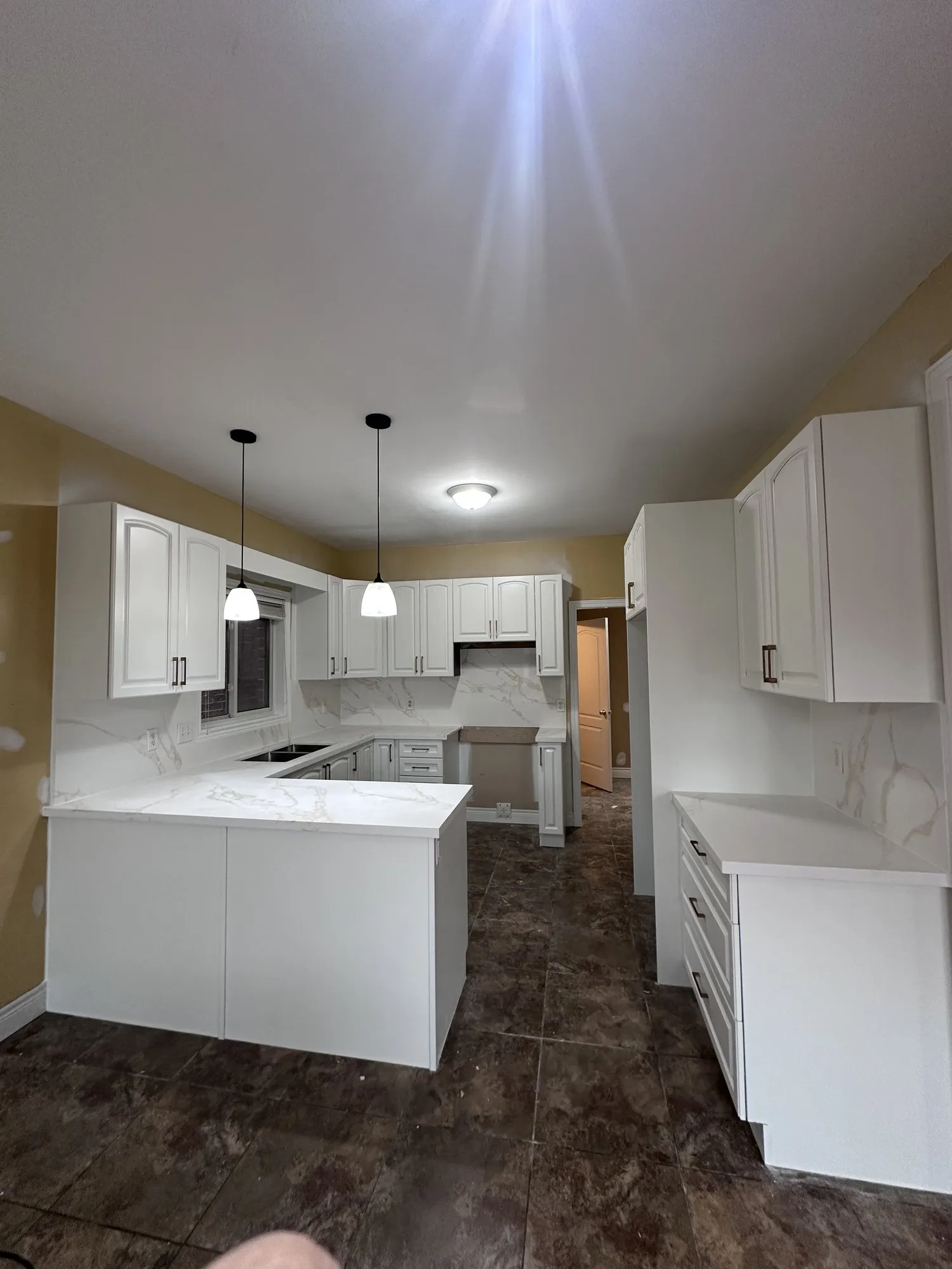 After — dark cherry sprayed white, new knobs and handles in Jerome, Hamilton