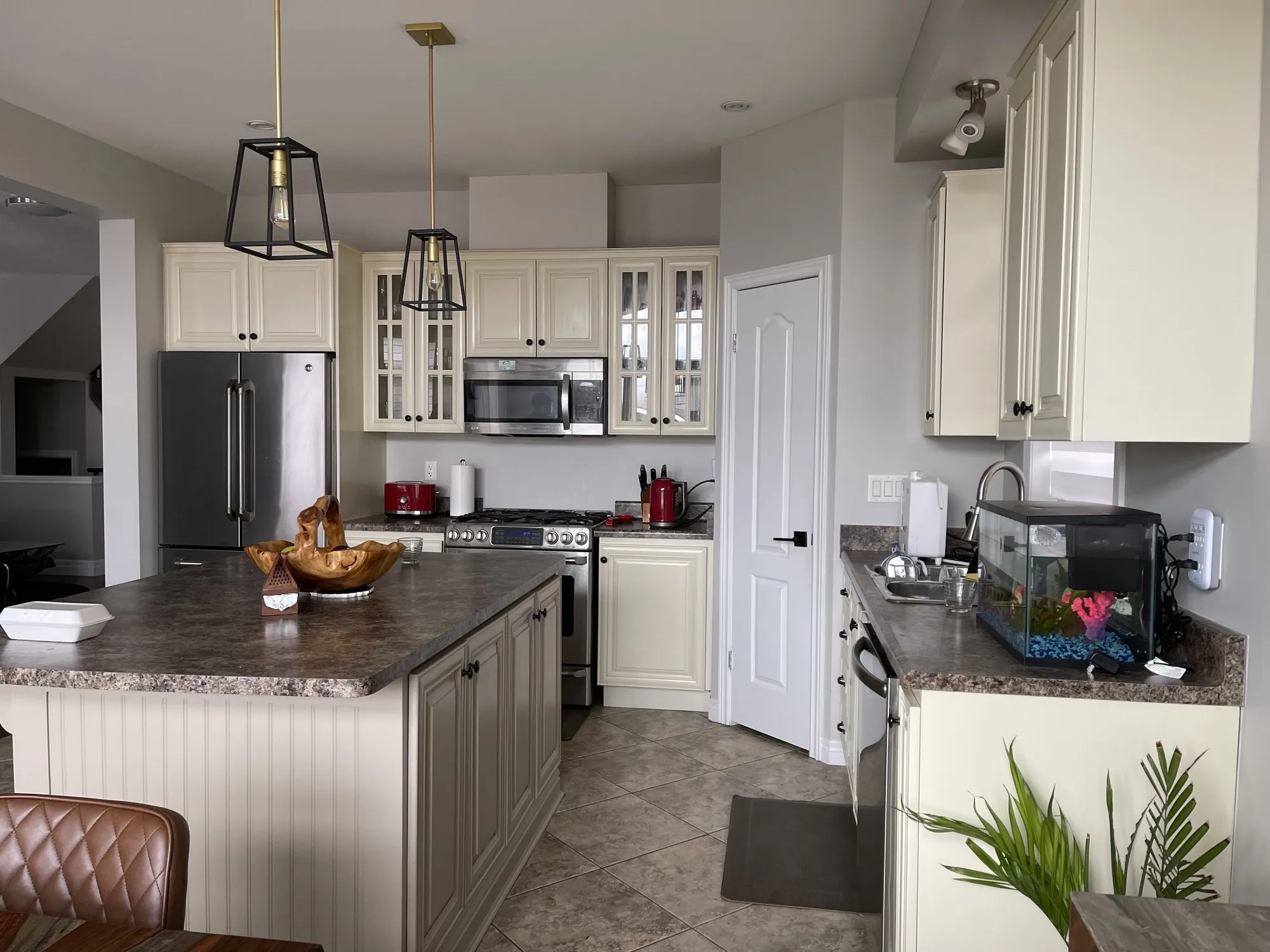 Before — cream cabinetry refinished white, counters and layout kept in Stoney Creek, Hamilton