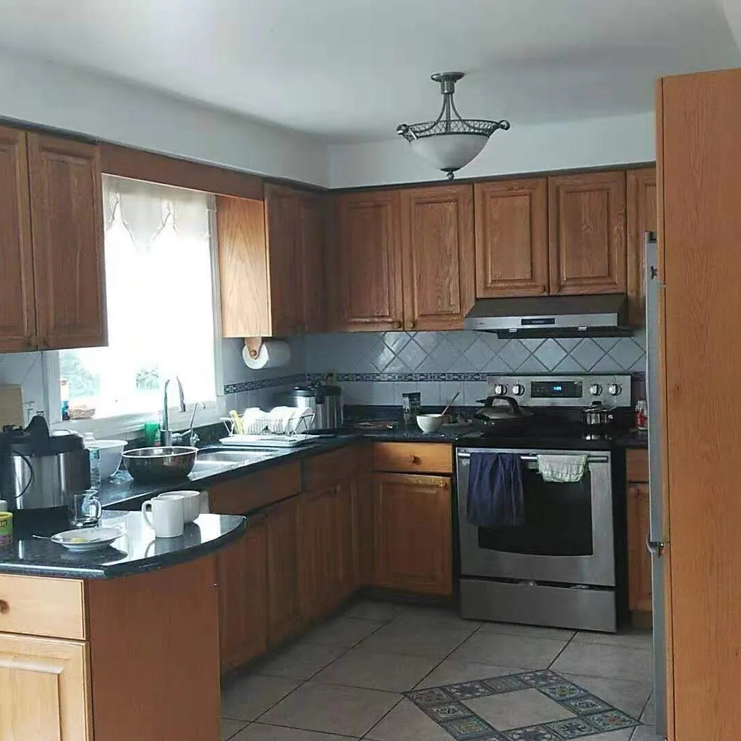 Before — Colour consultation in Winston Park, Oakville — golden oak taken to a soft grey, the counters and backsplash kept