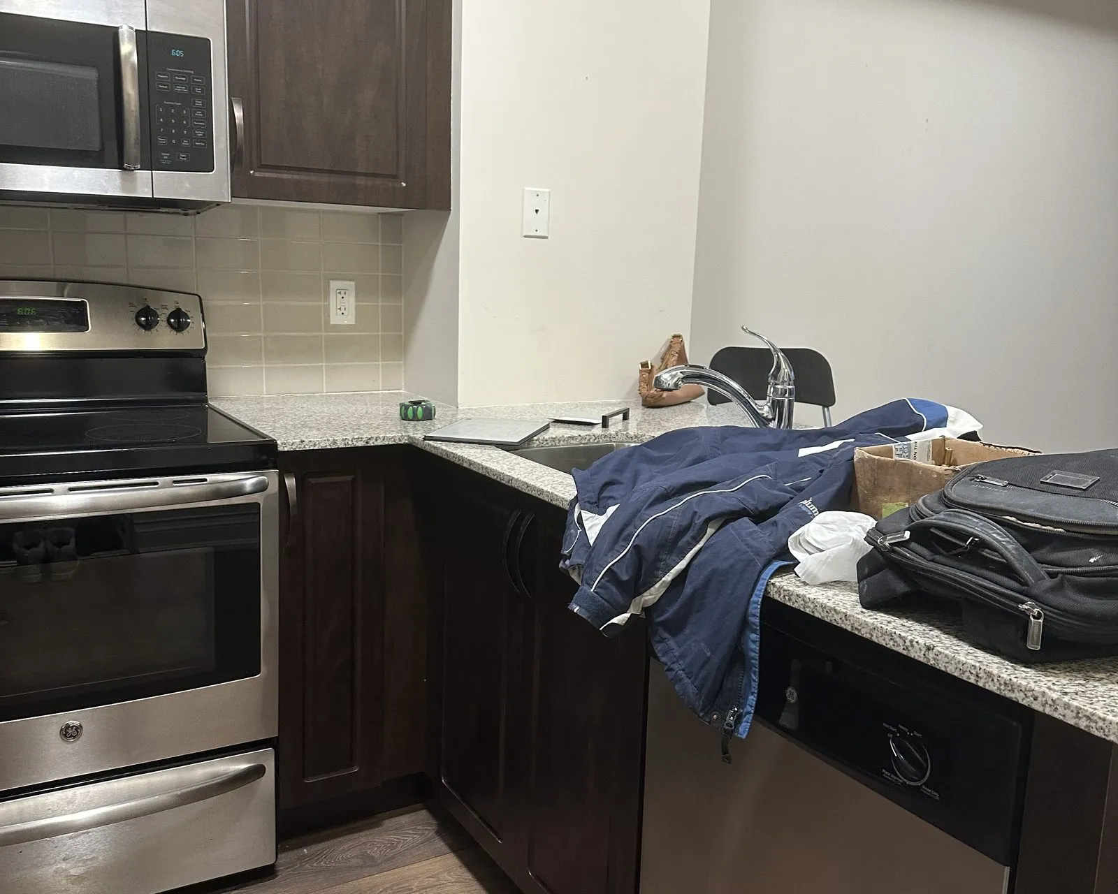 Before — Cabinet door replacement in Kerr Village, Oakville — espresso thermofoil doors on the original boxes, then new cashmere grey doors hung on the same carcases