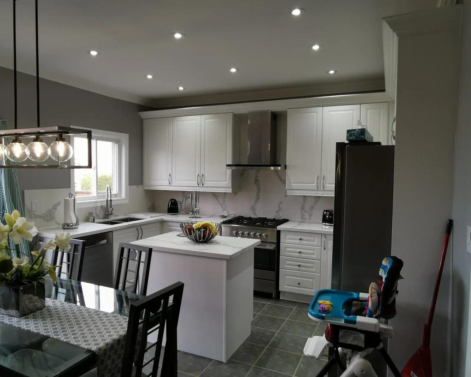 After — dark wood out, white cabinetry with a new island and hood — Bronte East, Oakville