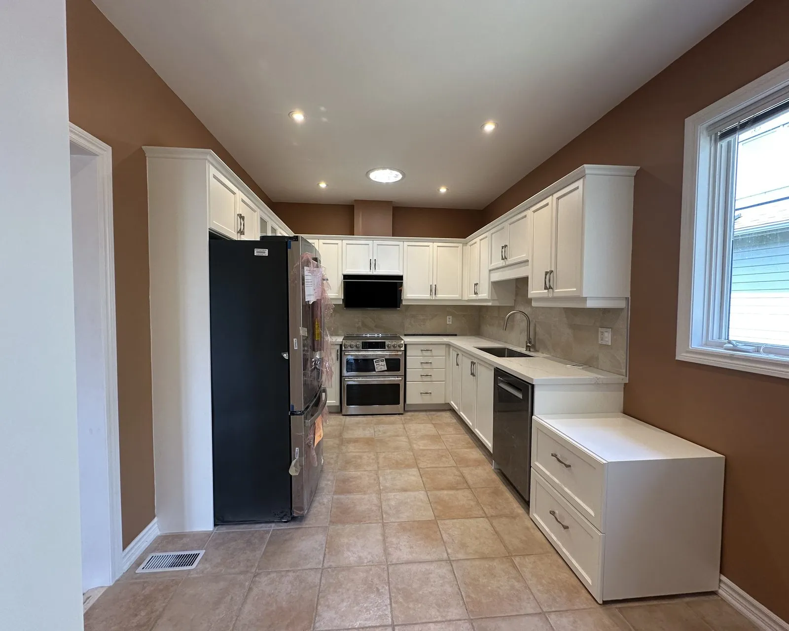 After — oak kitchen replaced, new white cabinetry throughout — Iroquois Ridge South, Oakville