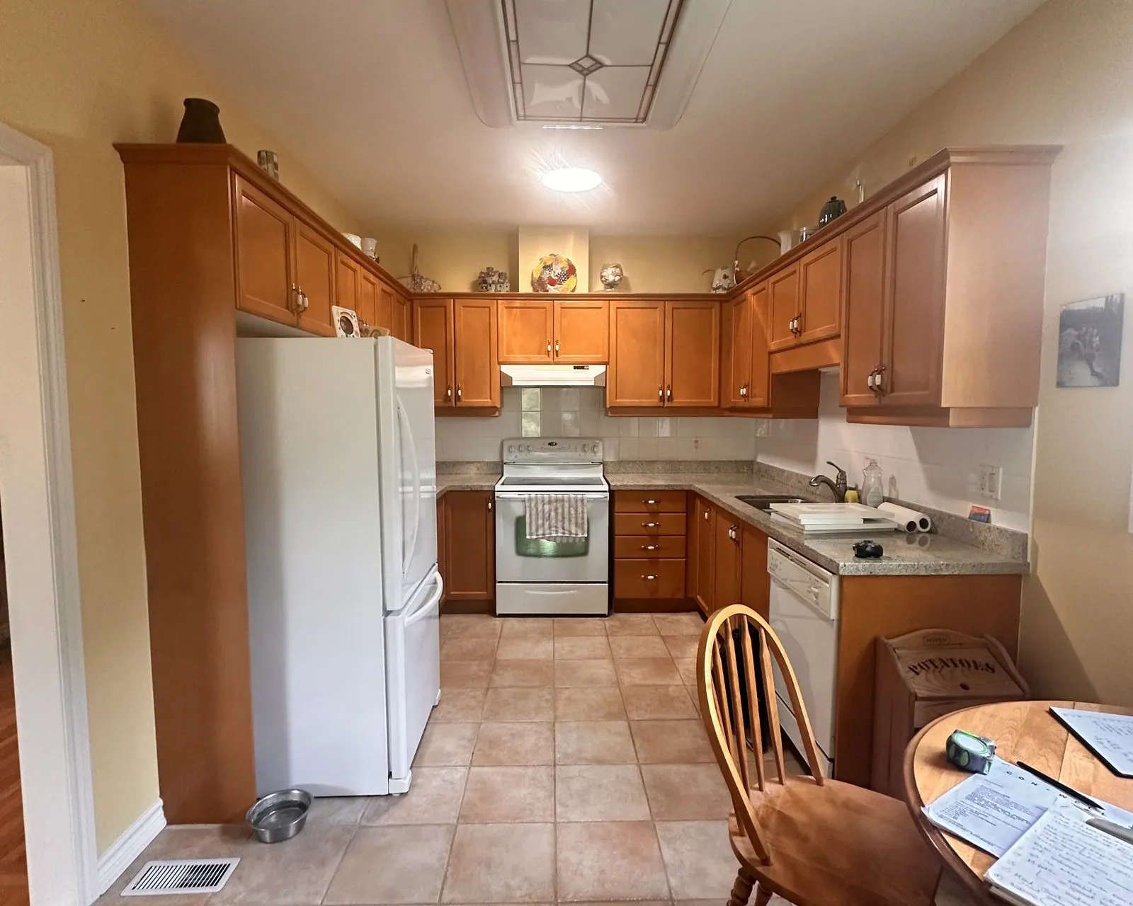 Before — oak kitchen replaced, new white cabinetry throughout — Iroquois Ridge South, Oakville
