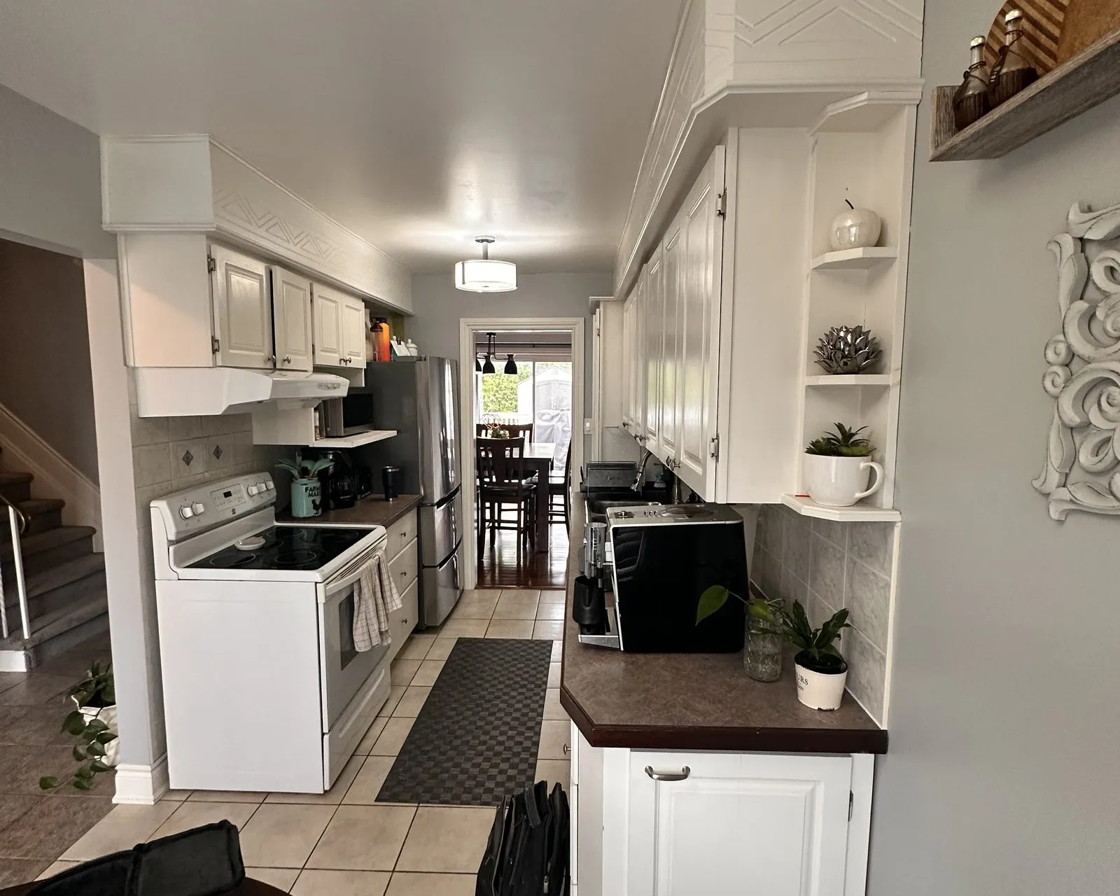 Before — Drawer box replacement in Ford, Oakville — a dated galley kitchen, then new cabinetry with fresh drawer boxes running on soft-close slides