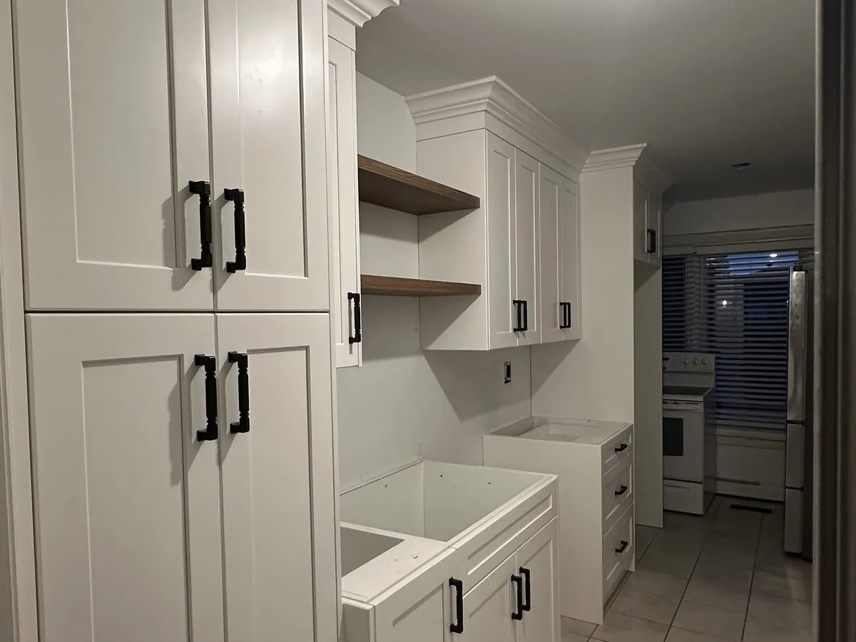 New plywood drawer boxes fitted into an open cabinet run, open shelving and cabinetry under construction