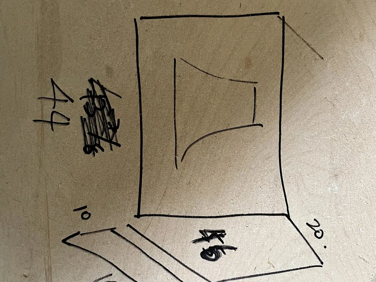 A hand-drawn cabinet layout dimensioned in marker on a wall stud, the measurements marked for a hood surround