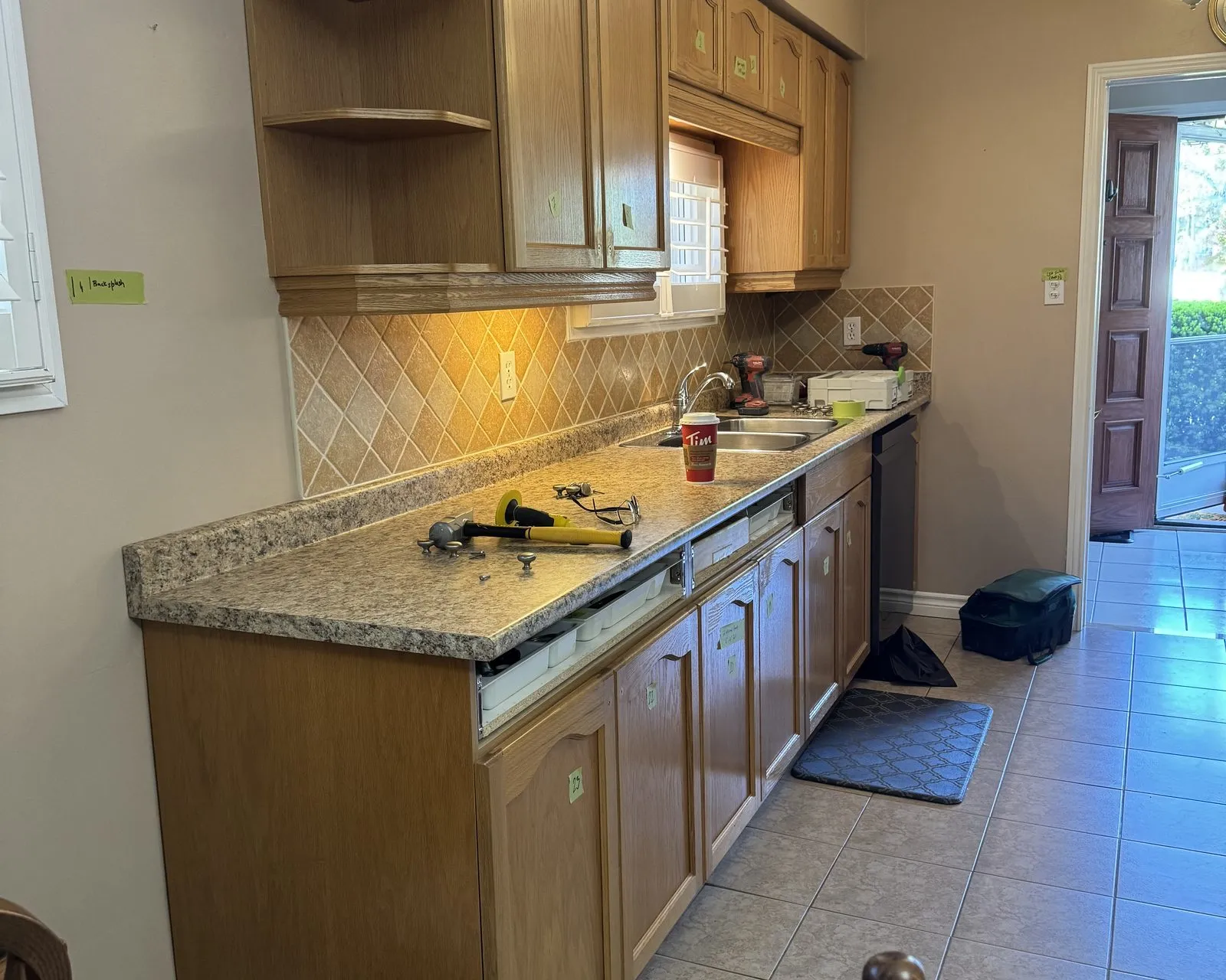 Before — golden oak sprayed white, new quartz and a slab backsplash — Bronte Creek, Oakville