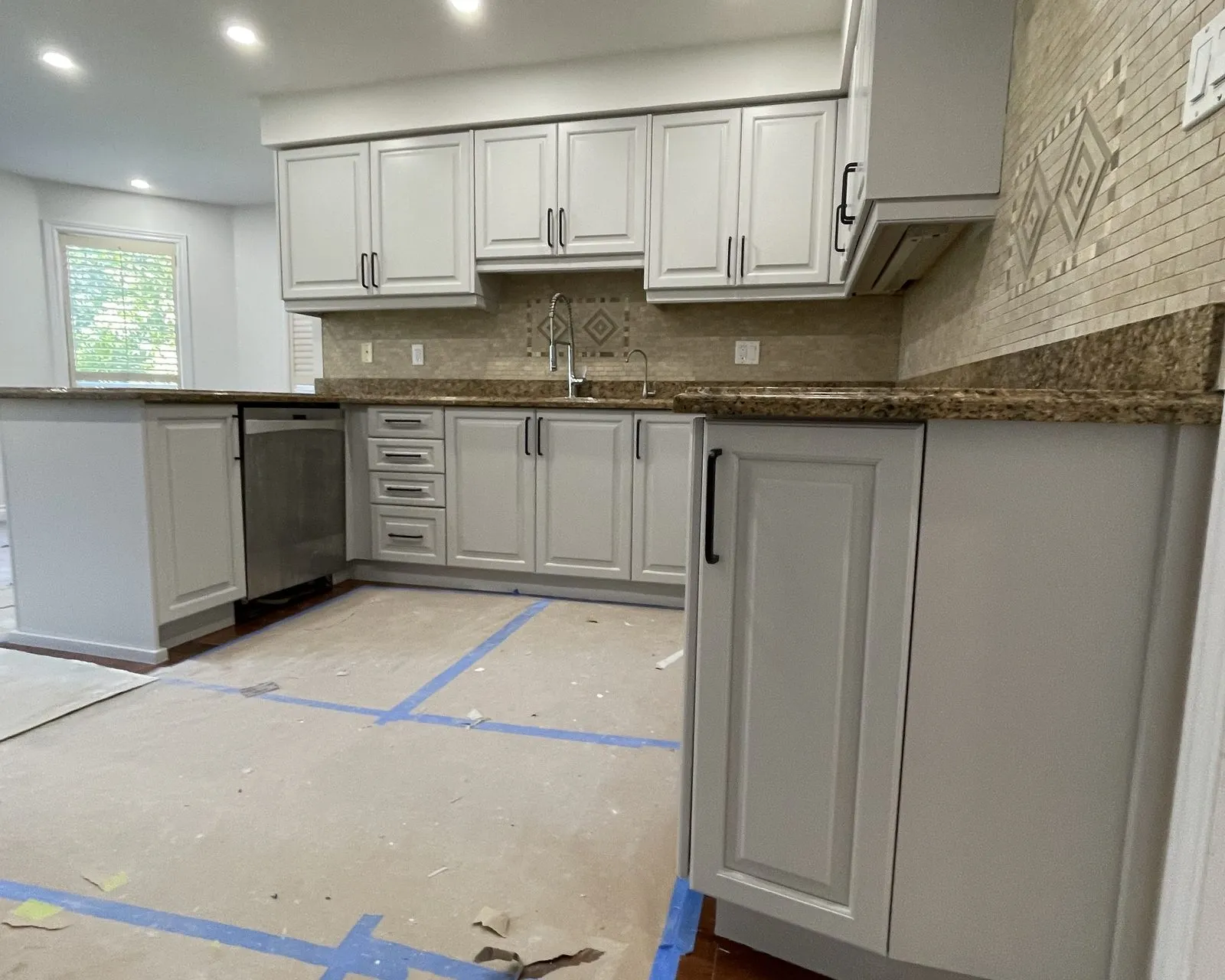 After — espresso sprayed white, granite and tile backsplash kept — Clearview, Oakville