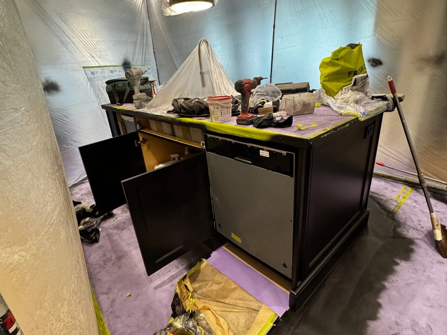 An island masked and its doors opened for spraying, the floor protected and the run sealed off