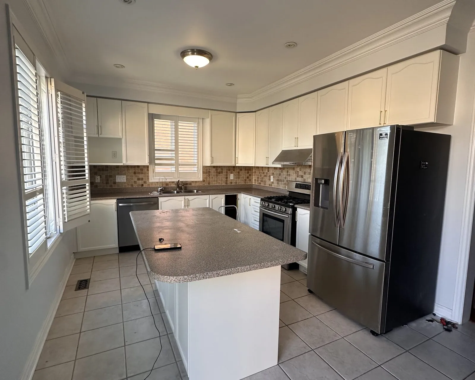 After — light maple sprayed white, granite kept — Iroquois Ridge North, Oakville