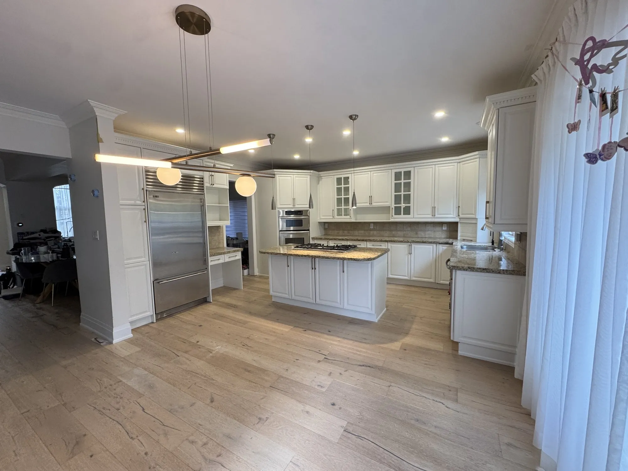 After — dark espresso sprayed Cloud White, kitchen and master vanity in Joshua Creek, Oakville