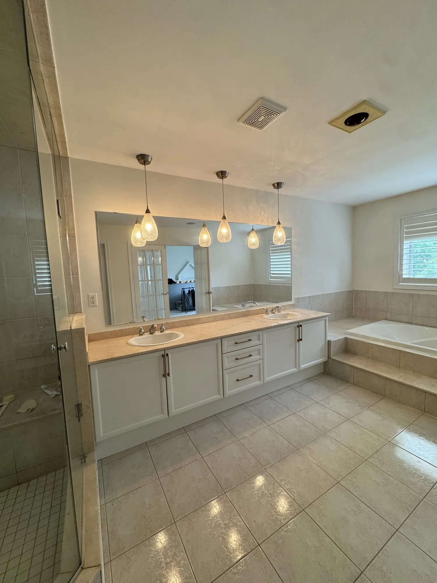 The master bedroom vanity after the work, a long double vanity sprayed the same white as the kitchen cabinets