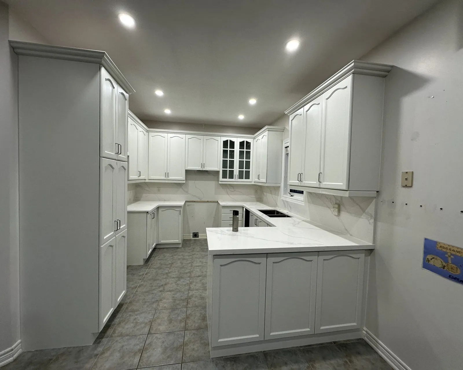 After — cherry sprayed white, new quartz and a slab backsplash — The Preserve, Oakville