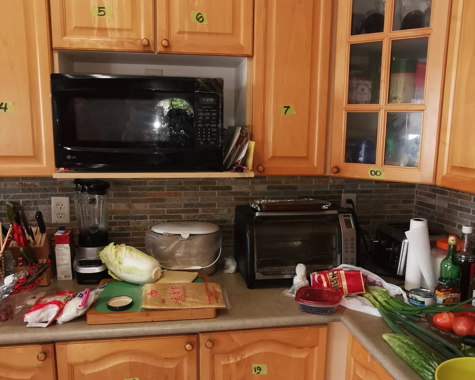 Before — honey oak sprayed white, double crown and new handles, counters and backsplash by others in Wedgewood Creek, Oakville