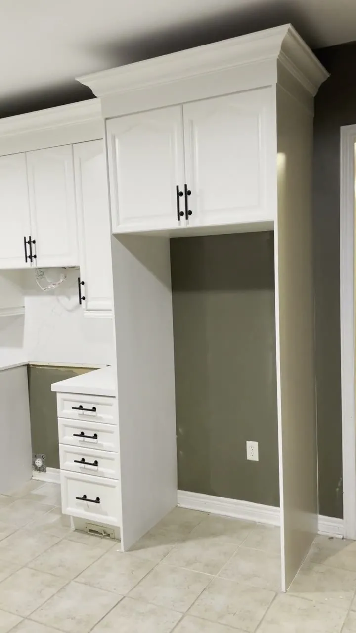 Walkthrough of the finished Wedgewood Creek kitchen — honey oak sprayed white with double crown and new handles, appliances not yet in