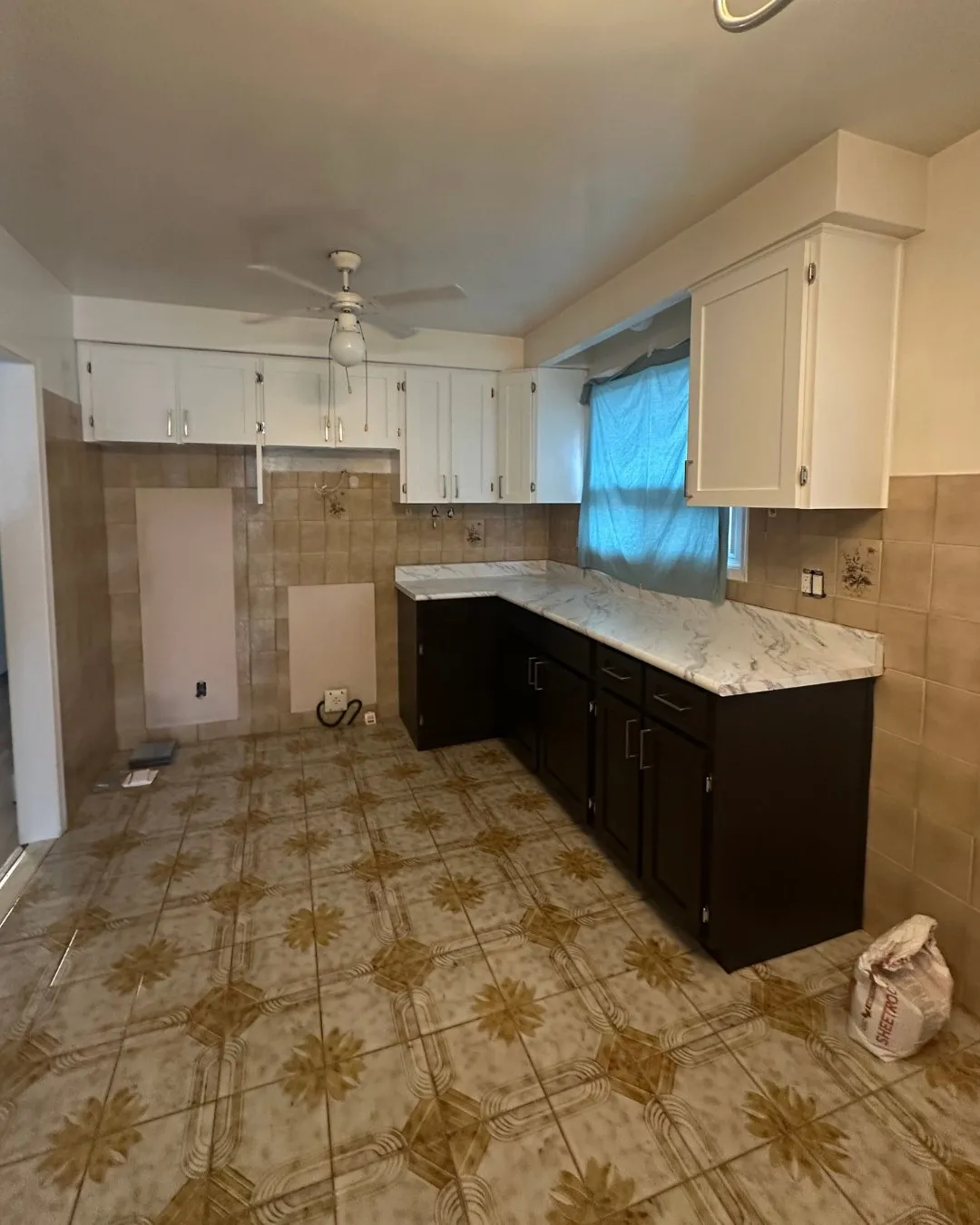 After — Kitchen cabinet refacing in Clearview, Oakville — oak raised-panel doors replaced with white shaker uppers and espresso lowers, and a new marble-look counter