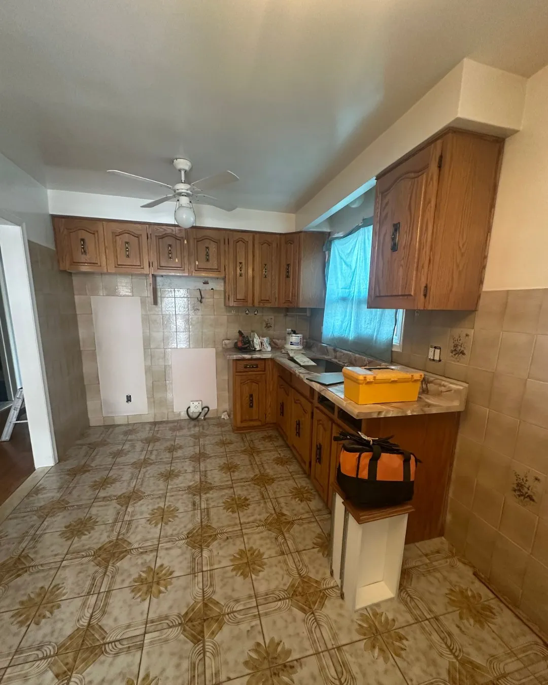 Before — Kitchen cabinet refacing in Clearview, Oakville — oak raised-panel doors replaced with white shaker uppers and espresso lowers, and a new marble-look counter