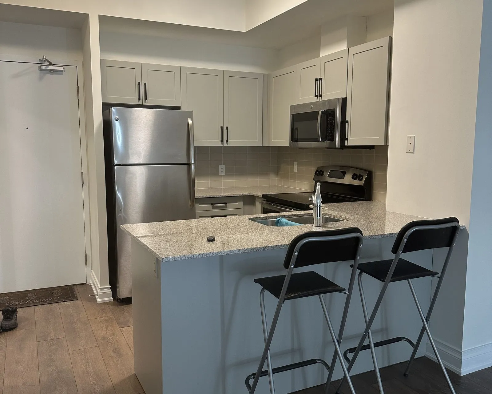 After — espresso thermofoil to cashmere grey, refaced — Kerr Village, Oakville