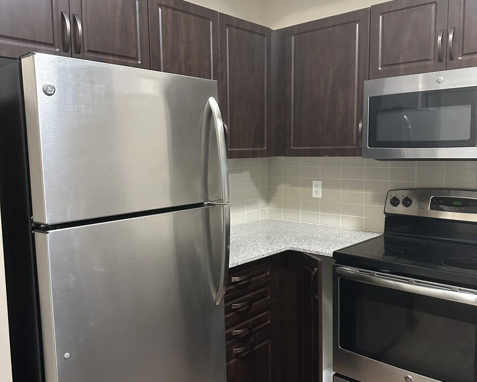 Before — espresso thermofoil to cashmere grey, refaced — Kerr Village, Oakville