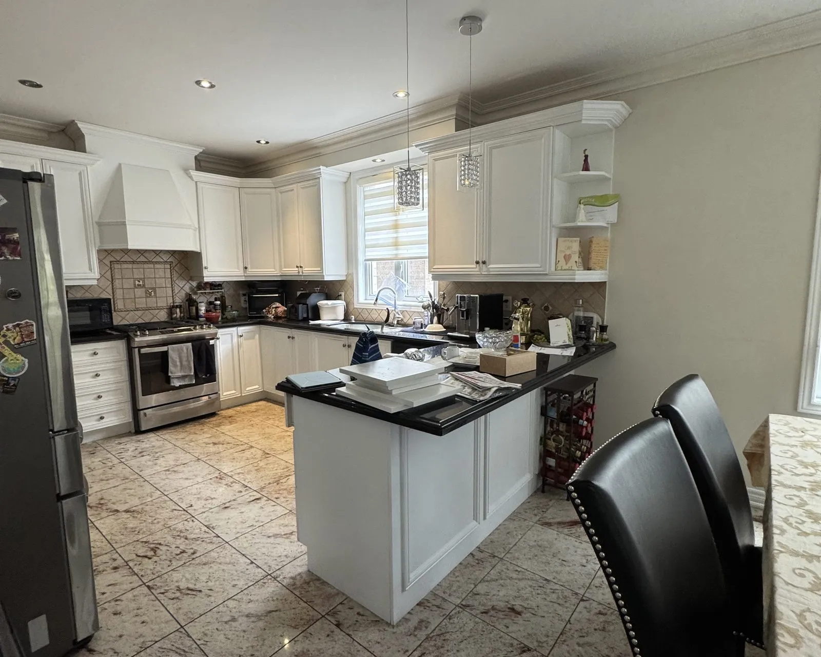 Before — cream raised-panel to white, granite kept — Lakeshore Woods, Oakville