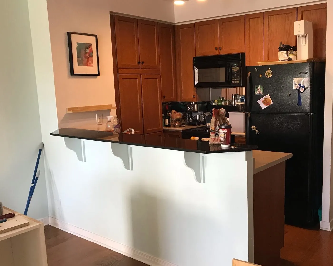 Before — cabinets added under the bar, oak to white — West Oak Trails, Oakville