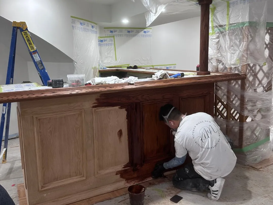 Stain going on over bare stripped timber, the line between finished and raw still showing
